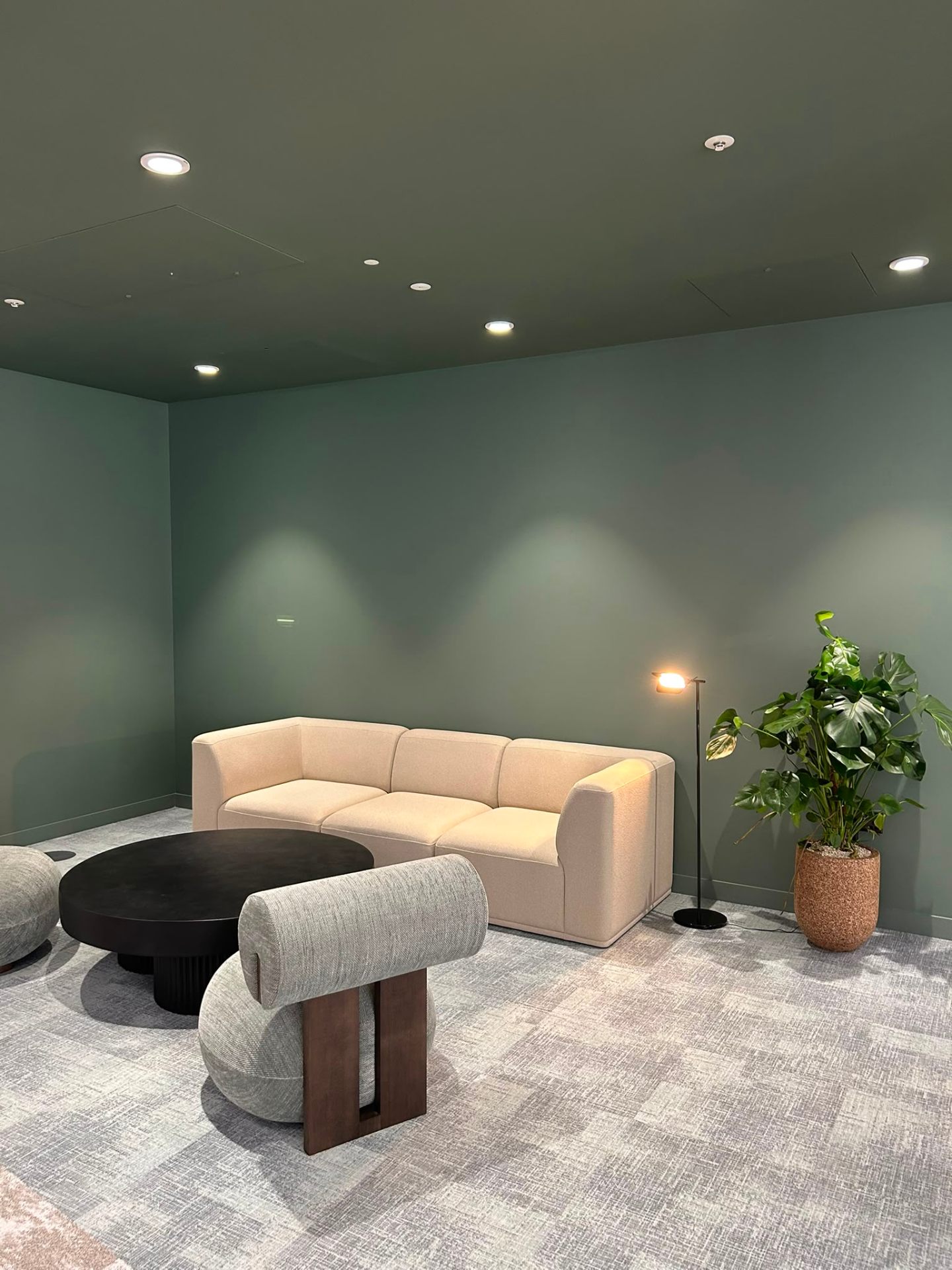 Interior renovation boutique lounge with sage green walls by MOVIR INTERIORS